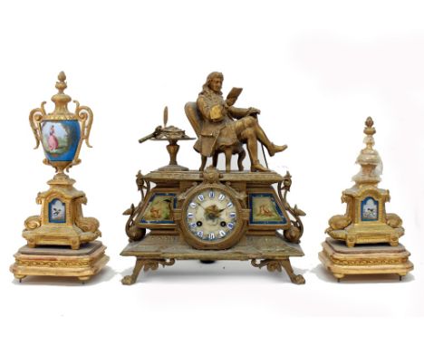 A Marti & Co:  A French gilt metal mantel clock, circa 1870, surmounted by a seated figure of an 18th century nobleman readin