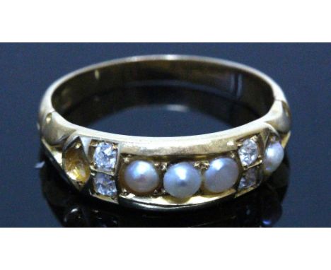 A Victorian 18ct gold, half-pearl and diamond gypsy ring, centred with three half pearls between pairs of small old cut diamo