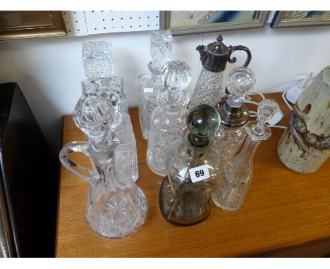 Collection of 8 Cut Glass Decanters and a Pressed glass Claret Jug with Silver plated top, Condition - Good Overall 