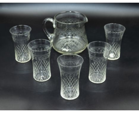 An etched glass pitcher and five glasses