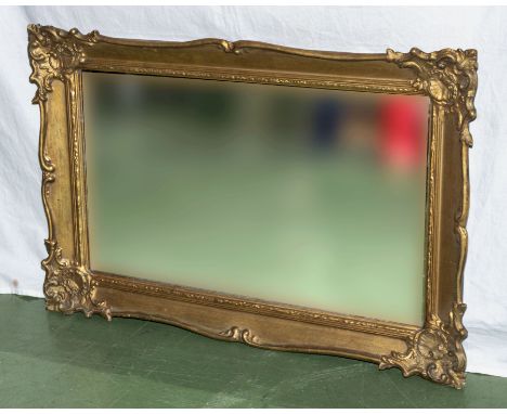 A gilt framed wall mirror