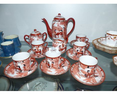 A Japanese tea set of "Lucky" design to include: coffee pot, sugar bowl, tea pot and six cups and saucers.