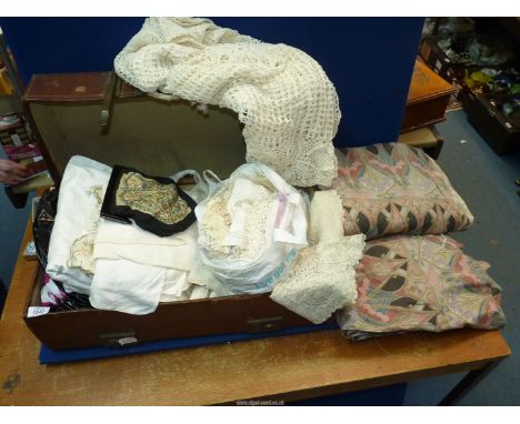 An old suitcase containing a quantity of tablecloths and linen to include; crochet, embroidered, lace, etc. plus a pair of pe