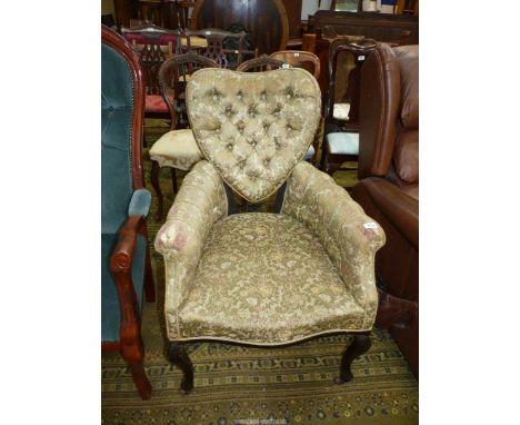 An unusual probably Edwardian button back Armchair, the backrest unusually in the shape of a heart and standing on cabriole f