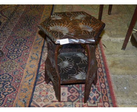 A hexagonal shaped profusely carved stool/table with lower shelf, 18'' tall