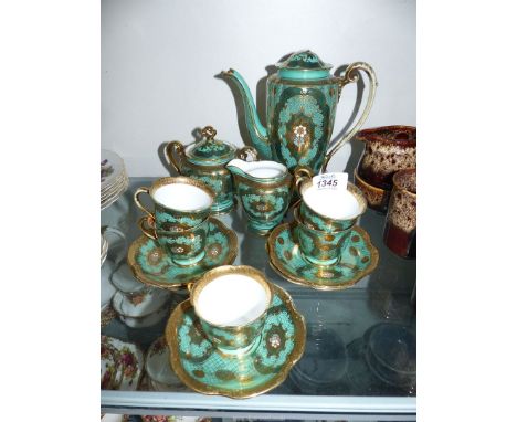 A green and gold Noritake tea set to include: a coffee pot (finial detached & spout repaired), sugar bowl (a/f), five cups an