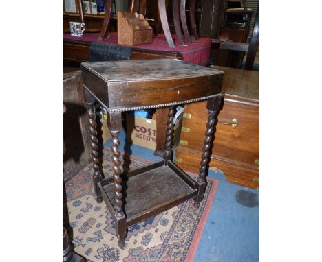 A bow fronted floor standing Oak cutlery Canteen standing on mirrored twist legs united by a lower shelf. The lid lifting to 