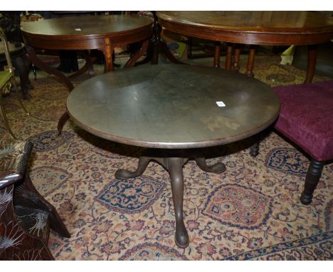A low Mahogany bird cage type Table having four turned supports, a turned central support with three splayed feet with hoof l