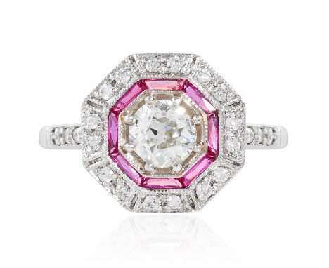 A DIAMOND AND RUBY DRESS RING in 18ct white gold, set with an old cut diamond of approximately 0.65 carats, between baguette 