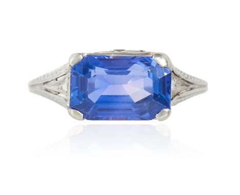 AN ANTIQUE SAPPHIRE AND DIAMOND DRESS RING in white gold or platinum, set with an emerald cut sapphire of 3.90 carats, with r