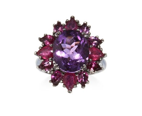 AN AMETHYST AND GARNET EARRING AND RING SUITE in silver gilt, comprising of a cluster of round, oval and pear cut amethyst an