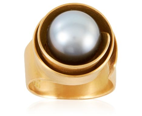 A PEARL RING in 18ct yellow gold, set with a 10.7mm great pearl within an abstract scrolling surround, full British hallmarks