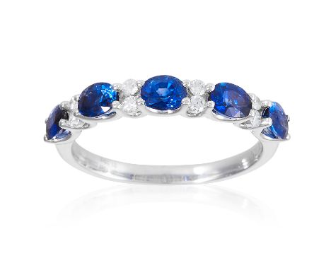 A SAPPHIRE AND DIAMOND ETERNITY RING in 18ct white gold, set with oval cut sapphires totalling approximately 1.10 carats and 