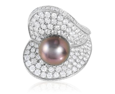 A PEARL AND DIAMOND DRESS RING, SCHOEFFEL in 18ct white gold, of abstract floral design, set with a 10.3mm round pearl within