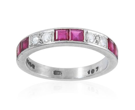 A DIAMOND AND RUBY HALF ETERNITY RING, in 18ct white gold, set with square cut rubies and round cut diamonds, full British ha