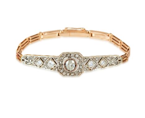 AN ANTIQUE RUSSIAN DIAMOND BRACELET in yellow gold and platinum, set with a central old cut diamond of approximately 0.70 car