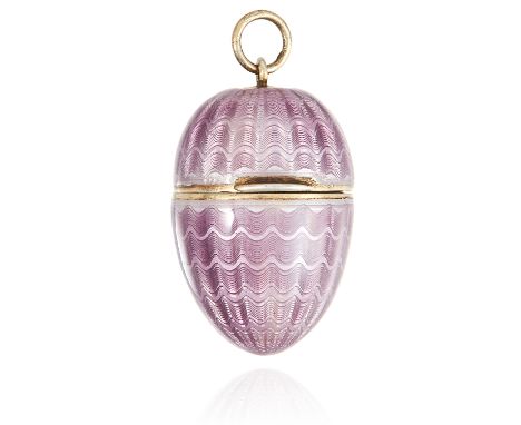 AN ANTIQUE ENAMELLED EGG PENDANT the hinged egg opening with hollow interior, the exterior decorated with translucent purple 
