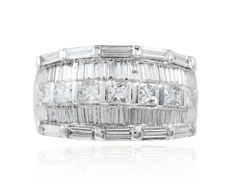 A DIAMOND DRESS RING in 18ct white gold, set with alternating rows of emerald, baguette and princess cut diamonds, stamped 18