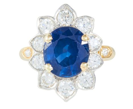 A 3.25 CARAT SAPPHIRE AND DIAMOND CLUSTER RING in yellow gold, set with an oval cut sapphire of approximately 3.25 carats and