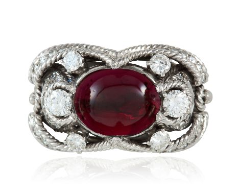 AN ART DECO GARNET AND DIAMOND RING 1940s in platinum or white gold, the oval cabochon garnet between round cut diamonds, in 