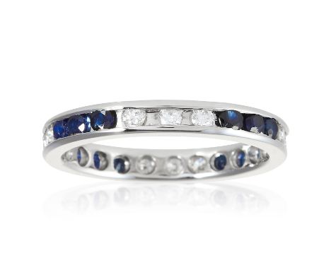 A SAPPHIRE AND DIAMOND ETERNITY RING in platinum, jewelled with alternating groups of three round cut sapphires and diamonds,