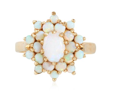 AN OPAL CLUSTER RING in yellow gold, set with a central oval cabochon opal in a cluster of cabochon opals, British hallmarks,