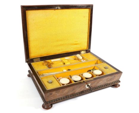 An Early 19th Century Rosewood Hinged Sewing Box, with mother-of-pearl inlay, bead banding around the lower edge, on four bal