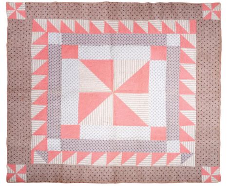 A 19th Century Cotton Patchwork Quilt, with a central square formed by pink and striped sprigged fabrics, within four outer f