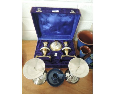 A portable candle stick and urn set possibly with religious interest