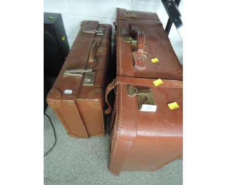 Two vintage leather bound suitcases or travel trunks