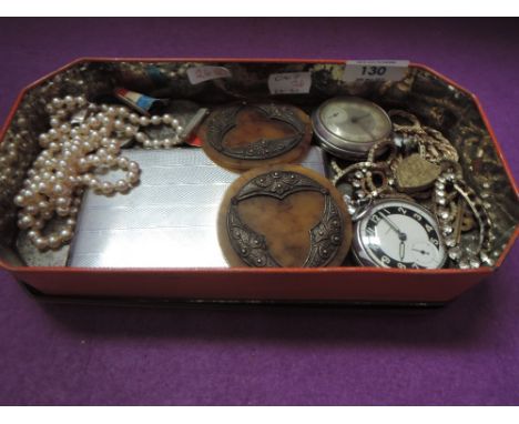 A vintage tin containing a selection of misc including two pocket watches, diamante, commemorative medals, cigarette case, pi