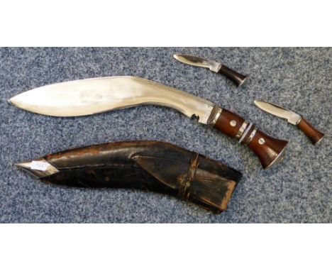 A Kukri in scabbard with skinning knives