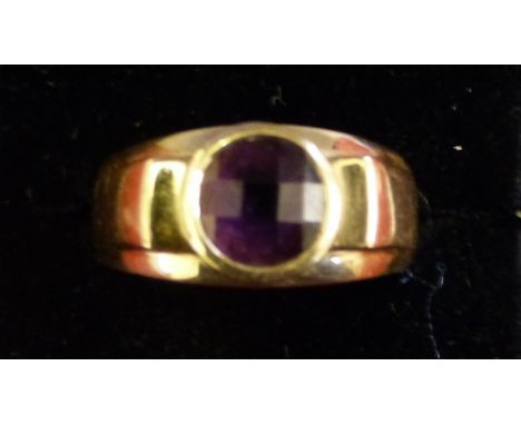 A 9ct gold and amethyst dress ring collet set with a facetted stone, weight 7 grams