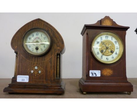 A mahogany inlaid mantel clock on raised circular feet together with an oak cased mantel clock with mother of pearl inlay (2)