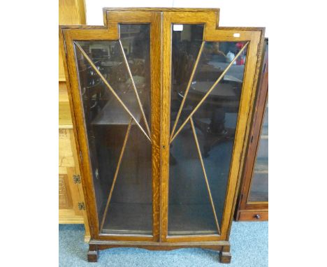 An Art Deco style oak two-door display cabinet with split level top and block feet, 91cm wide, 150cm high