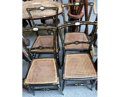 A set of four Victorian mother-of-pearl inlaid and gilt decorated ebonised cane seat bedroom chairs (4)