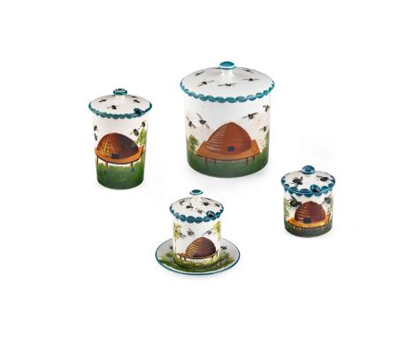   FOUR 'BEES & HIVE' HONEY JARS & COVERS to include a 'BEES & HIVE' HONEY JAR HOLDER & COVER, glazed earthenware, painted mak