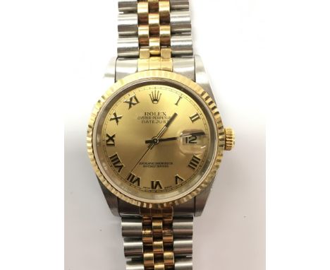 A gents Rolex oyster perpetual Datejust chronometer wristwatch, the gold dial presenting gold Roman numerals, magnified date 