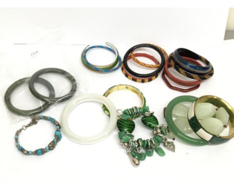 A collection of bracelets inducing Jade, Glass &amp; Opal, Malachite etc. Postage cat B