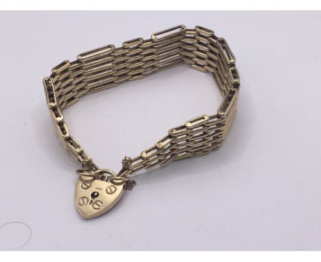 A 9carat gold gate bracelet with a padlock clasp. Weight 26g