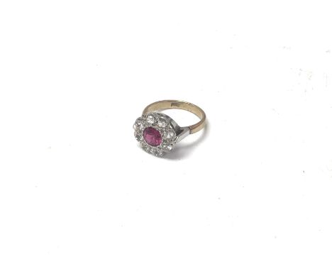 A 9ct gold ring set with a ruby and and white stones, Approx 3.65 grams. Ring size M.