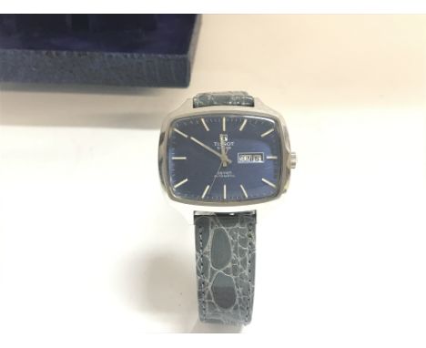 A vintage Tissot watch with box. With winds and runs. Approximately 39mm case. Postage B