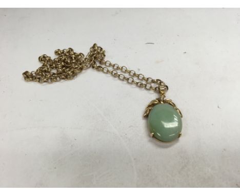 A 9ct gold and jade pendant on a 9ct gold chain. Approx 10.9 grams. (A)