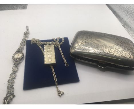 A silver cigarette case and a silver 1977 pendant and chain and a marquisette watch. (3)