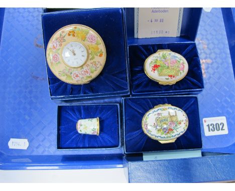 A Halcyon Days Enamel Clock, two trinket pots 1981 and 1982 and a thimble, all cased.