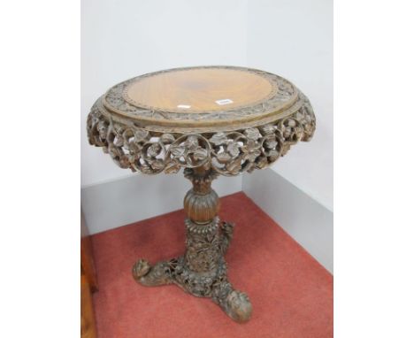 XIX Century Burmese Hardwood Snap Top Table, of circular form, heavily carved with foliage, on tiered pedestal tripod legs te