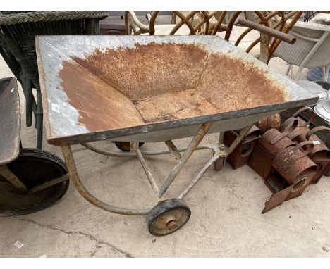 A VINTAGE METAL CART WITH THREE WHEELS 