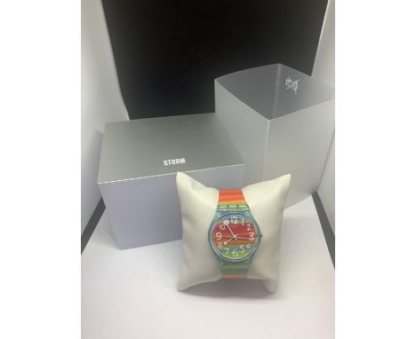 A COLOURFUL SWATCH WATCH IN A PRESENTATION BOX SEEN WORKING BUT NO WARRANTY 