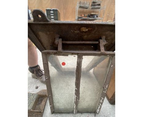 A VINTAGE CAST IRON CELLAR WINDOW 