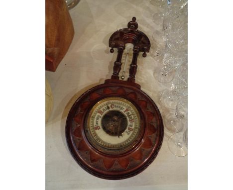 A VINTAGE ORNATE WOODEN CASED BAROMETER WITH THERMOMETER 